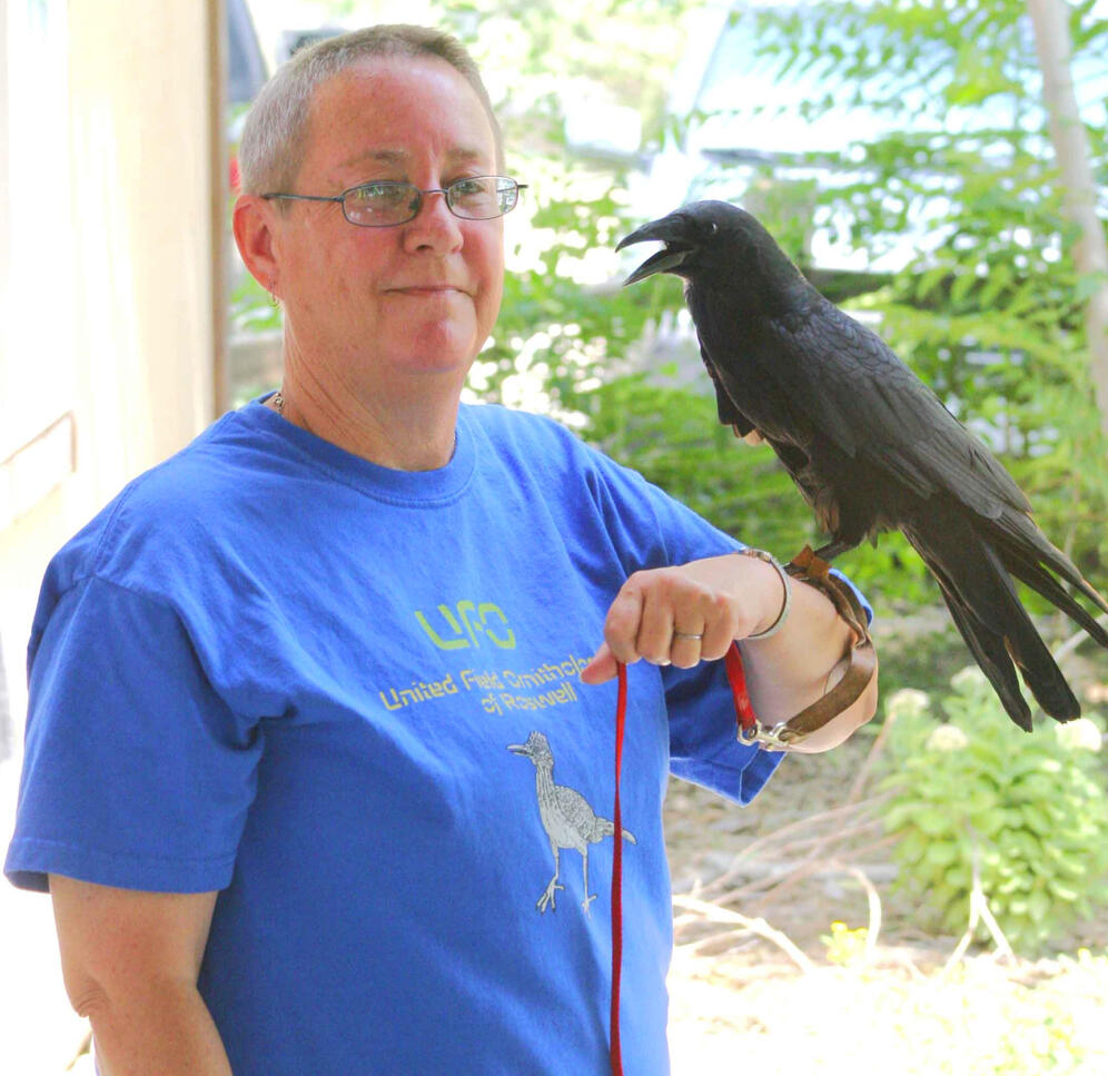 Laney holding Quoth, a Chihuahuan Raven